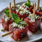 Vibrant skewers of watermelon, feta, and mint leaves, a refreshing no-cook Mediterranean snack for any gathering.