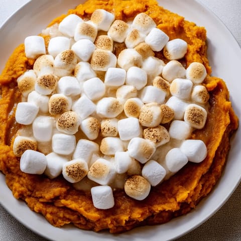Golden brown Sweet Potato Casserole, topped with toasted marshmallows, ready to be served warm.