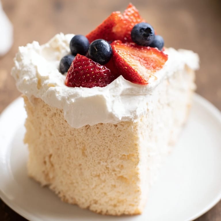 A beautiful, airy angel food cake, baked to perfection and soon to be topped with fresh berries.