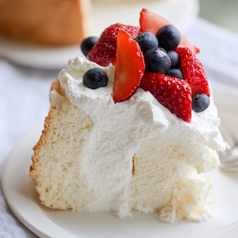 Light and sweet, this angel food cake towers high, beckoning to be enjoyed with a fork.