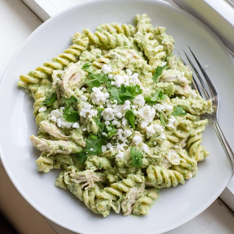 Fresh cilantro lime chicken pasta served in a rustic dish, garnished with lime wedges and cotija cheese, ready for a healthy weeknight dinner.