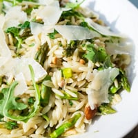Thin ribbons of shaved asparagus and tender orzo are tossed with a bright lemon dressing, topped with shaved Parmesan and toasted pine nuts.  